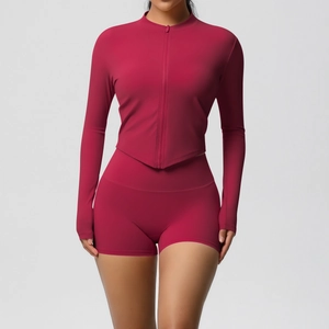 Close-up of the dark red yoga set showing the zipper stand collar and thumbhole sleeves