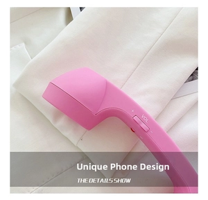 Close-up of pink retro telephone receiver strap accessory with volume control dial