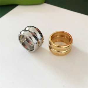 Detail of chunky gold and silver stackable rings with high-polished stainless steel finish
