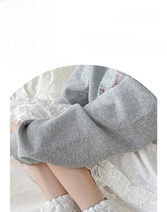 Détail de chaussettes en coton gris clair avec bordure en dentelle blanche délicate