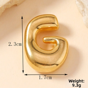 Detailed view of golden bubble letter G pendant with measurements 2.3cm by 1.7cm and 9.3g weight