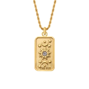 Macro shot of 18k gold plated rectangular sun tarot pendant with celestial details