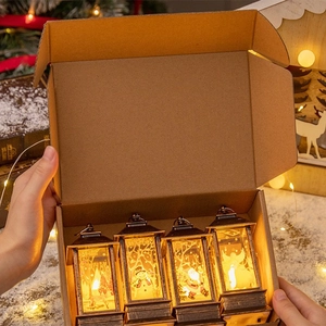 Set of four Christmas LED lanterns with festive patterns in a brown gift box