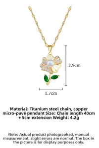 Macro detail of titanium steel floral pendant with pavé zircons and green leaf gem