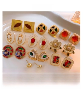 Macro shot of vintage gold-plated enamel earrings with pearls and crystals in detail