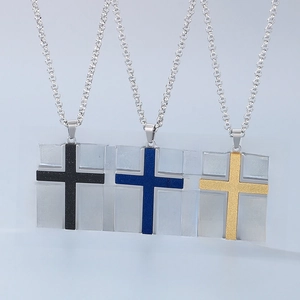 Detailed view of stainless steel cross necklaces in black, blue, and golden finishes