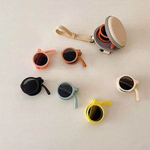 Detailed view of colorful foldable round kids sunglasses with matching carrying cases
