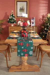 Detailed Christmas table runner and placemat set with red ornaments on dark green fabric