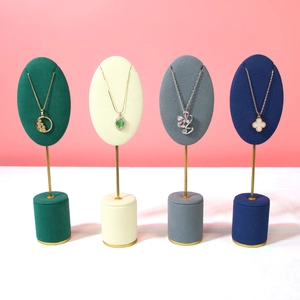 Four-piece velvet jewelry necklace display stands with gold metal poles and stable bases