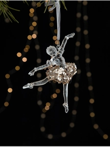 Detail of transparent ballerina Christmas ornament with gold sequins and silk ribbon hanging