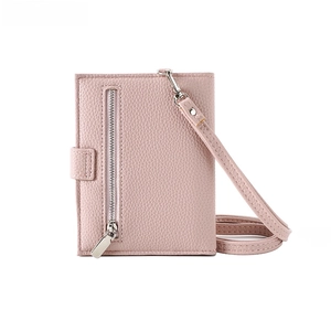 Detail of light pink pebble leather passport wallet with silver zipper and snap closure