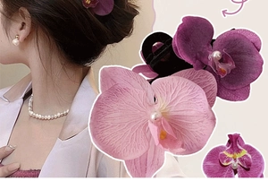 Detailed view of artificial orchid hair clips with realistic petal texture and pearls