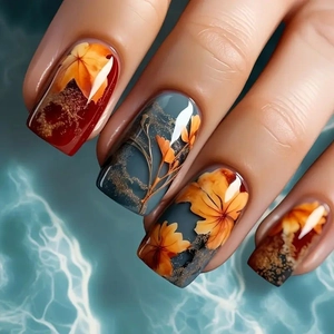 Glossy square press-on nails with autumn maple leaf and floral designs in deep red
