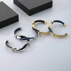 Twisted C-shaped titanium steel bracelet with braided leather cord and cubic zirconia