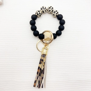 Silicone bead keychain bracelet with leopard print tassel and gold geometric accents
