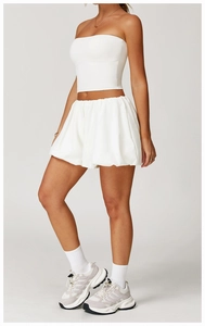 Side view of white high-waist yoga shorts and matching bandeau top in a minimalist style
