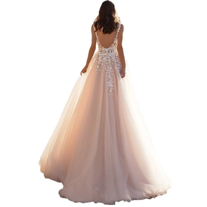 Detail of elegant backless champagne tulle dress with white floral lace embroidery