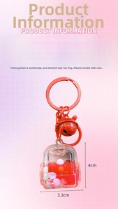 Detail of red liquid quicksand schoolbag keychain with colorful beads and small bell