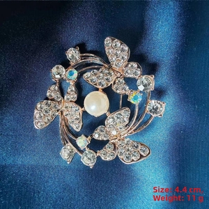 Detail of rose gold butterfly brooch with pearls and crystals measuring 4.4cm in diameter