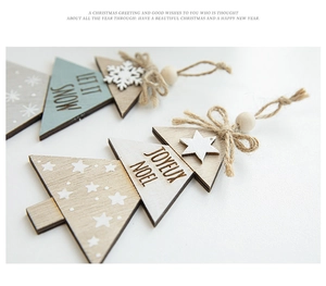 Close-up of wooden Christmas tree ornaments with Let It Snow text and snowflakes
