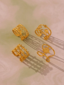 Detail of four-piece set golden irregular hollow geometric rings with bohemian sun and moon
