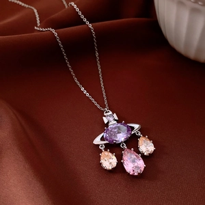 Macro shot of Saturn pendant necklace with purple zircon and colorful teardrop stones