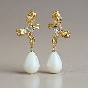 Retro butterfly bow earrings with cubic zirconia and white waterdrop pendants in gold