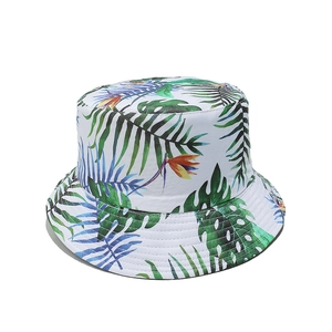 Close-up of tropical palm leaf print and neat stitching on a white summer sun hat