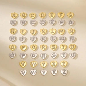 Micro shot of 26 gold and silver crystal heart alphabet charms for DIY jewelry making