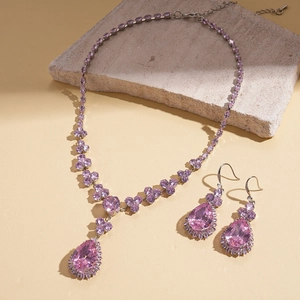 Detail view of purple teardrop zircon pendant necklace and matching flower earrings