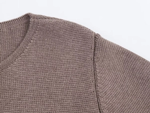 Detail of the ribbed neckline and dense knit texture on this cocoa brown cardigan