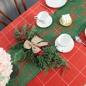Christmas table runner with red plaid patterns, green lace trim and festive pine cone decor