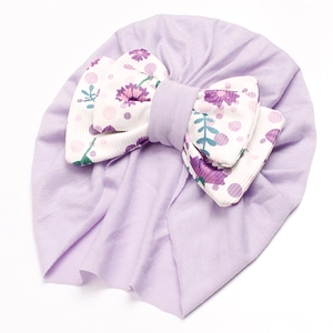Close-up of soft light purple baby turban hat featuring a floral print bow decoration