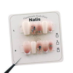 Pink and cream gradient press-on nails set with rhinestone accents and silver lines