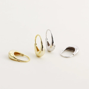 Minimalist 925 silver hoop earrings in polished gold and silver finishes on white background