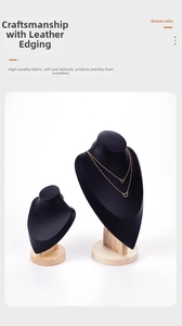Detail of black leather necklace stands with wooden base and gold jewelry display