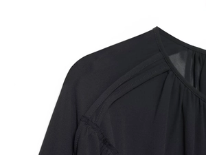 Detail shot of pleated neckline and shoulder stitching on black chiffon blouse top