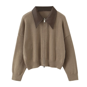 Detailed view of brown knit cardigan with faux leather collar and metal zipper closure