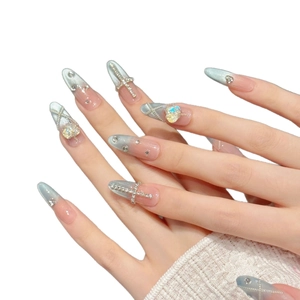 Handmade almond press-on nails with blue blush cat eye effect and heart gems