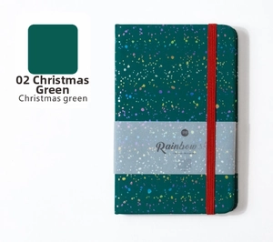 Detail of Christmas green A5 notebook with colorful polka dots and red elastic band