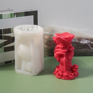 Detailed silicone mold and finished red wax rose held by a skeletal hand with skulls