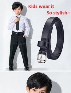 Detail of black faux leather kids belt with silver metal buckle and lychee texture