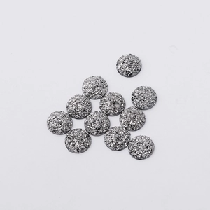 Close-up of 12mm silver resin druzy cabochons with sparkling crystalline texture