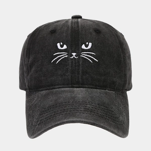 Detail of cute cat face embroidery on a vintage washed black cotton baseball cap