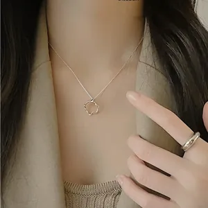 Close-up of minimalist silver 925 irregular ring and geometric pendant necklace for women