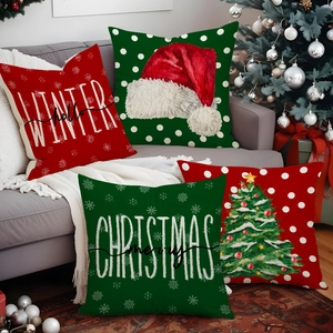 Set of 4 Christmas pillow covers with Santa hat and tree motifs on a grey sofa