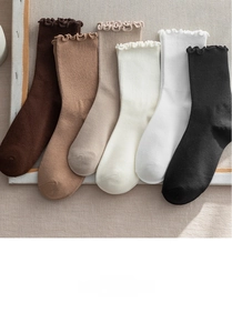 Detailed view of women's ribbed knit crew socks with ruffled edges in six neutral colors