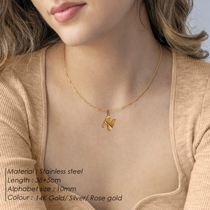 Model wearing gold stainless steel necklace with letter N pendant and size specs