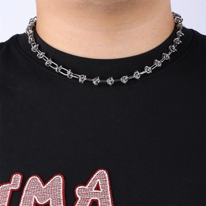 Detail of silver knot chain necklace on male model with polished stainless steel finish