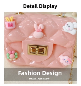 Detail of pink jelly crossbody bag with quilted texture and 3D cartoon charms